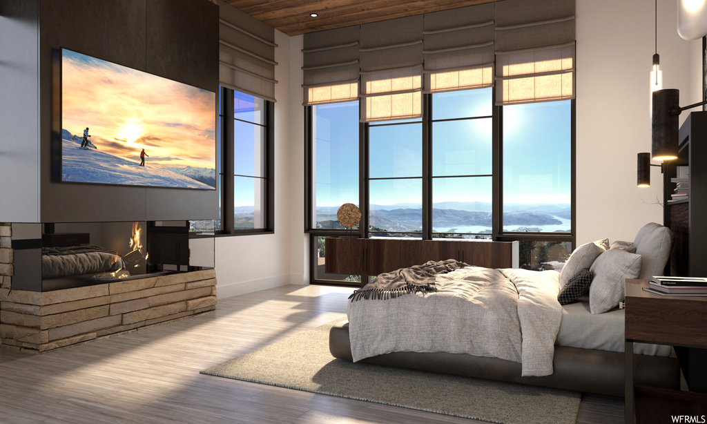 Bedroom featuring multiple windows, light hardwood flooring, and wooden ceiling