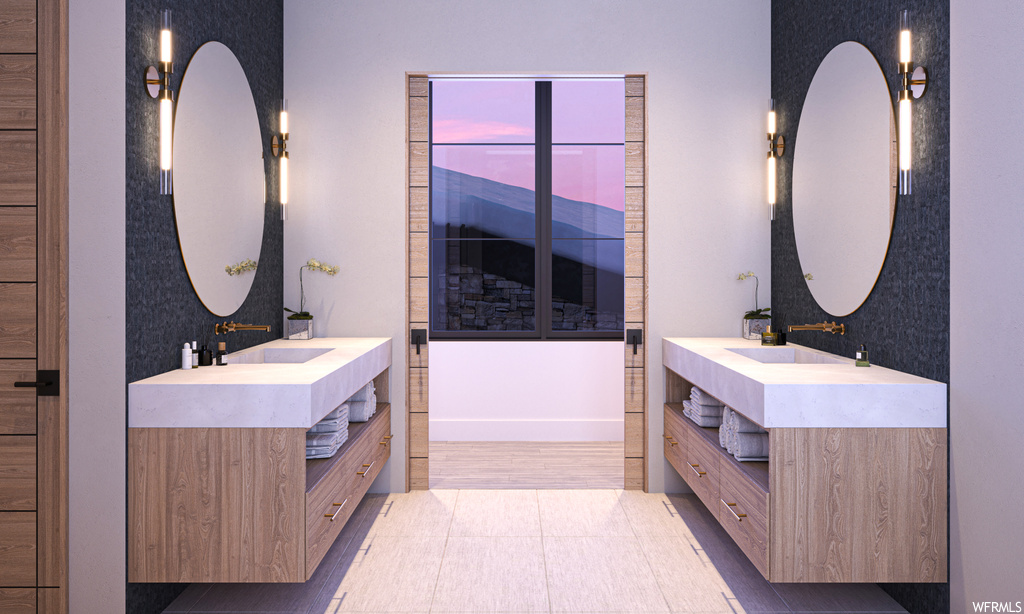 Bathroom featuring dual vanity, mirror, and light tile floors