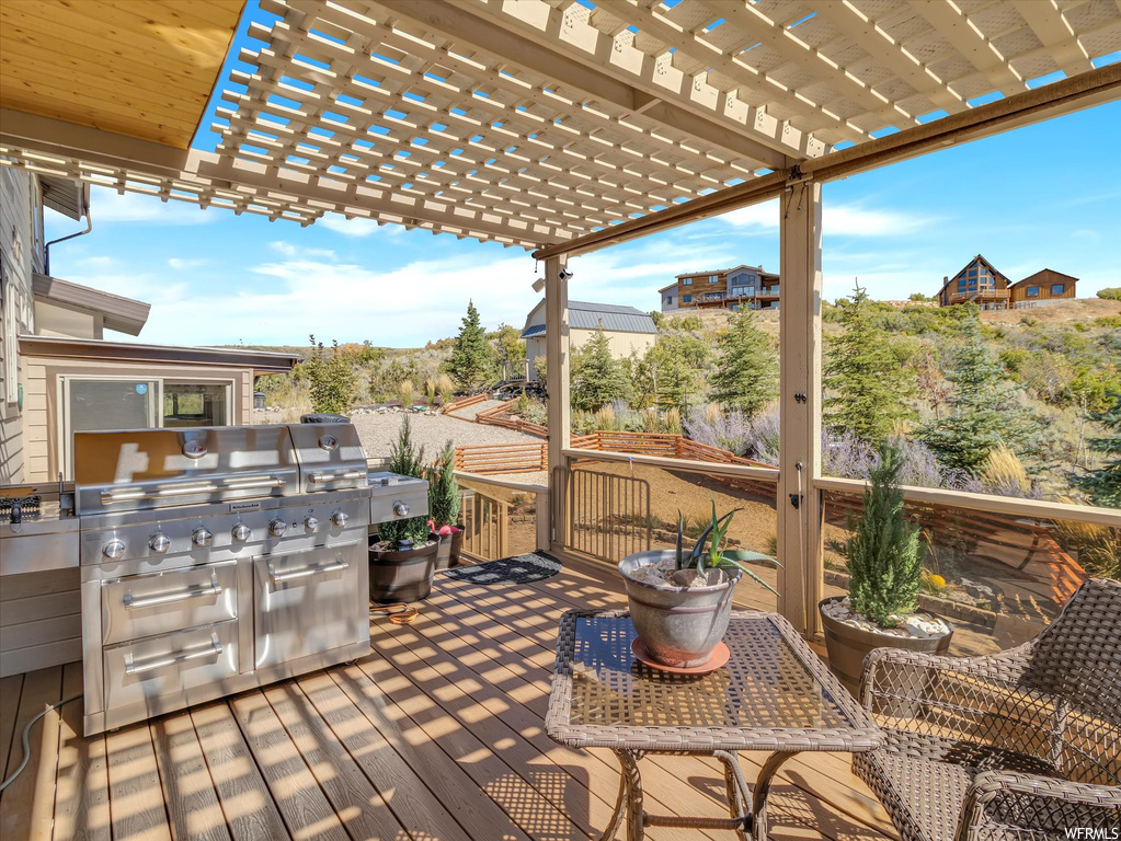 Deck with a pergola and grilling area