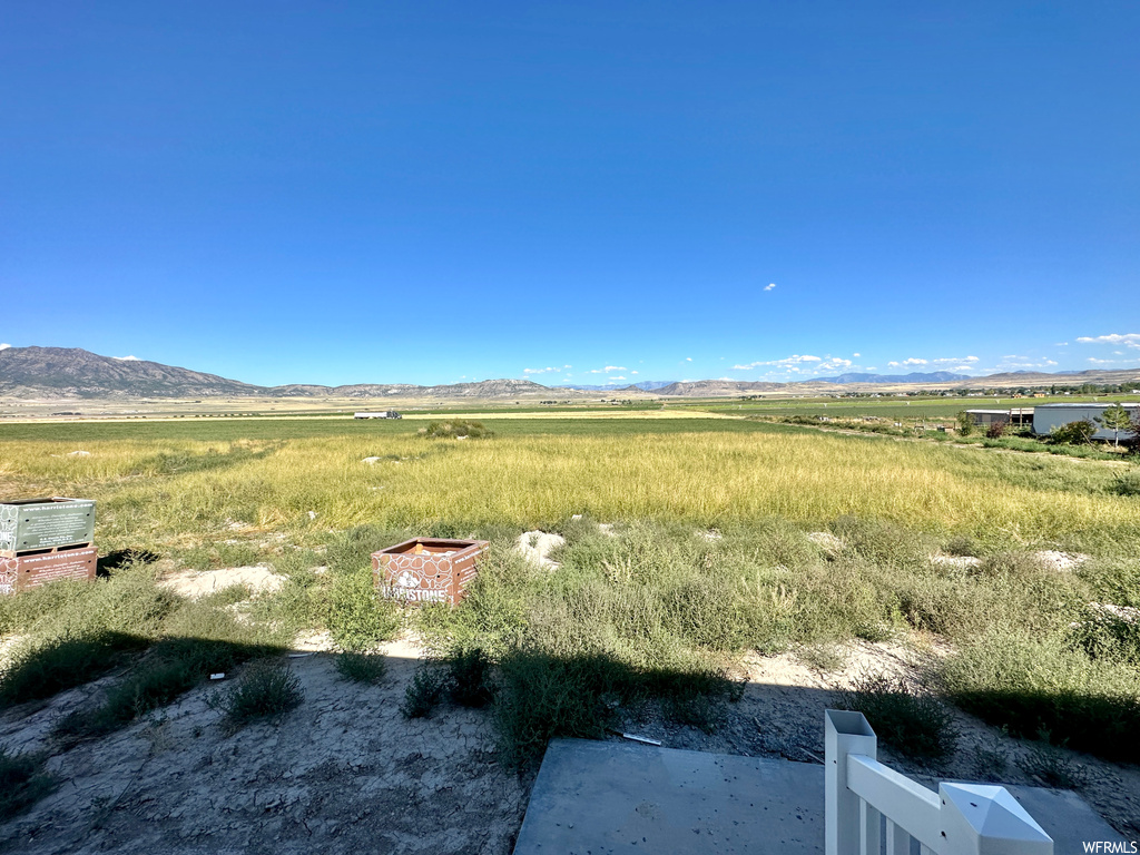 View of yard featuring a mountain view and an outdoor fire pit