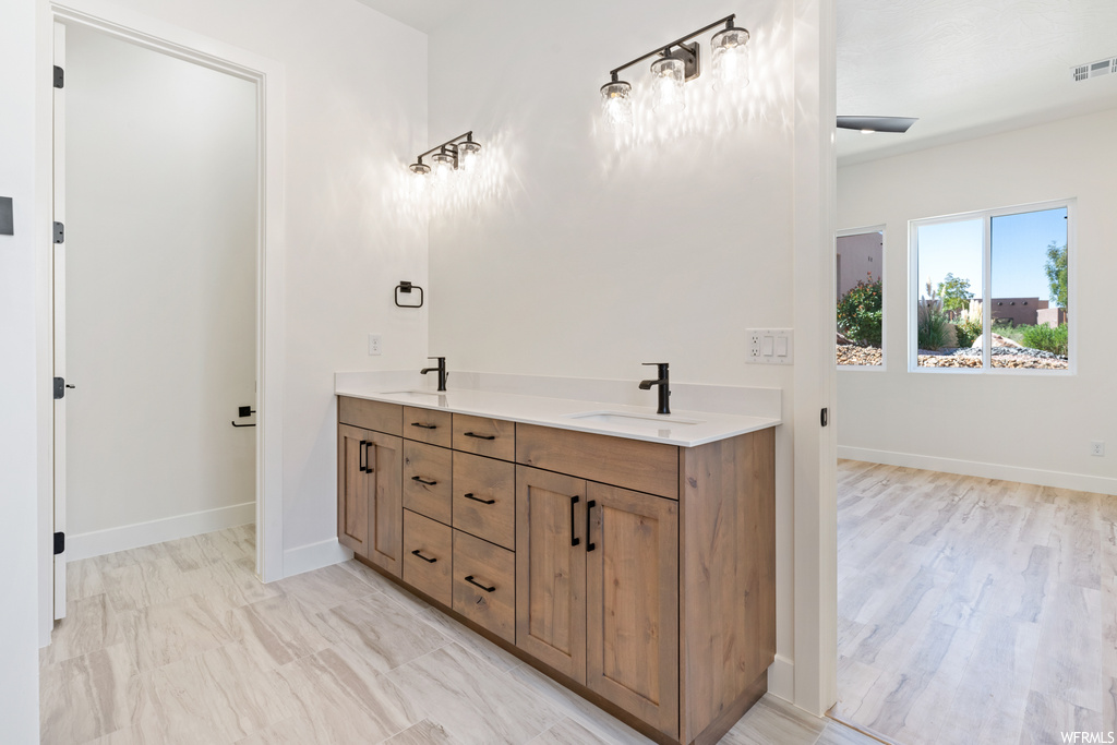 Bathroom with double sink vanity and hardwood floors