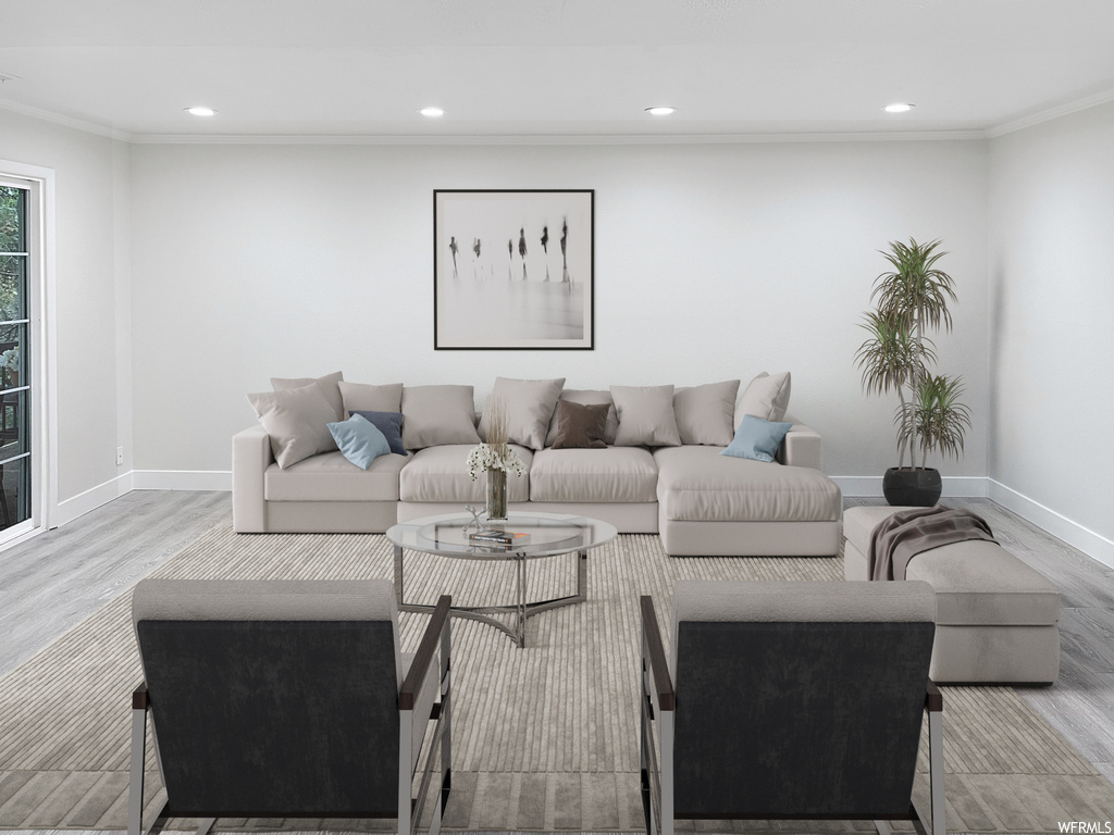 Living room featuring light hardwood floors and ornamental molding