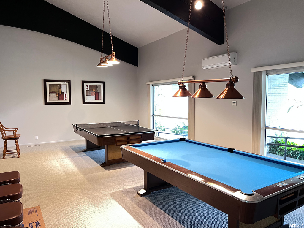 Recreation room with plenty of natural light, light carpet, an AC wall unit, and billiards