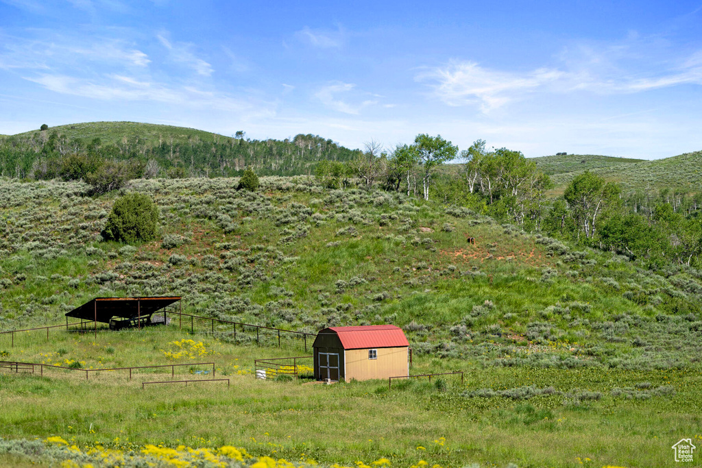 View of yard featuring a mountain view, an outdoor structure, and a rural view