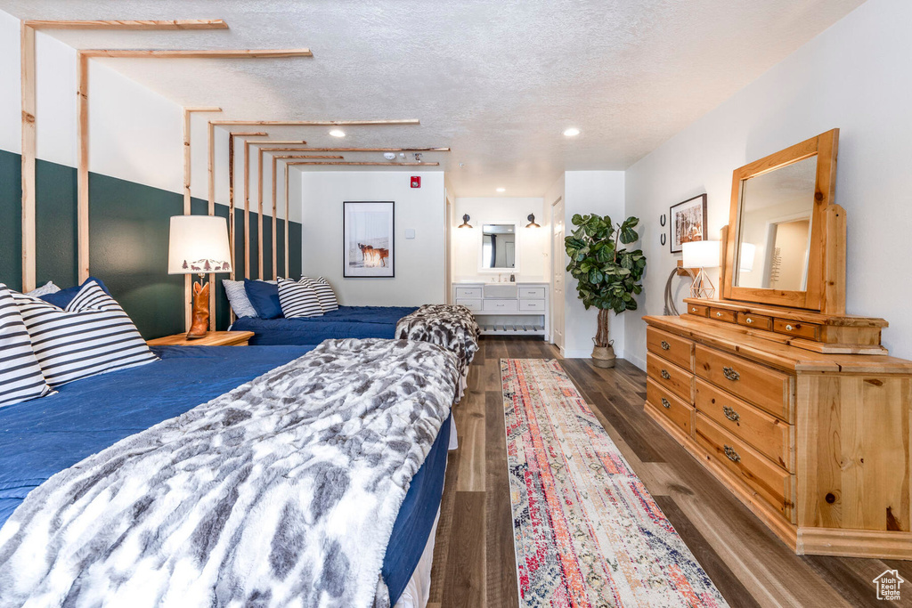 Bedroom featuring dark wood-type flooring and a textured ceiling