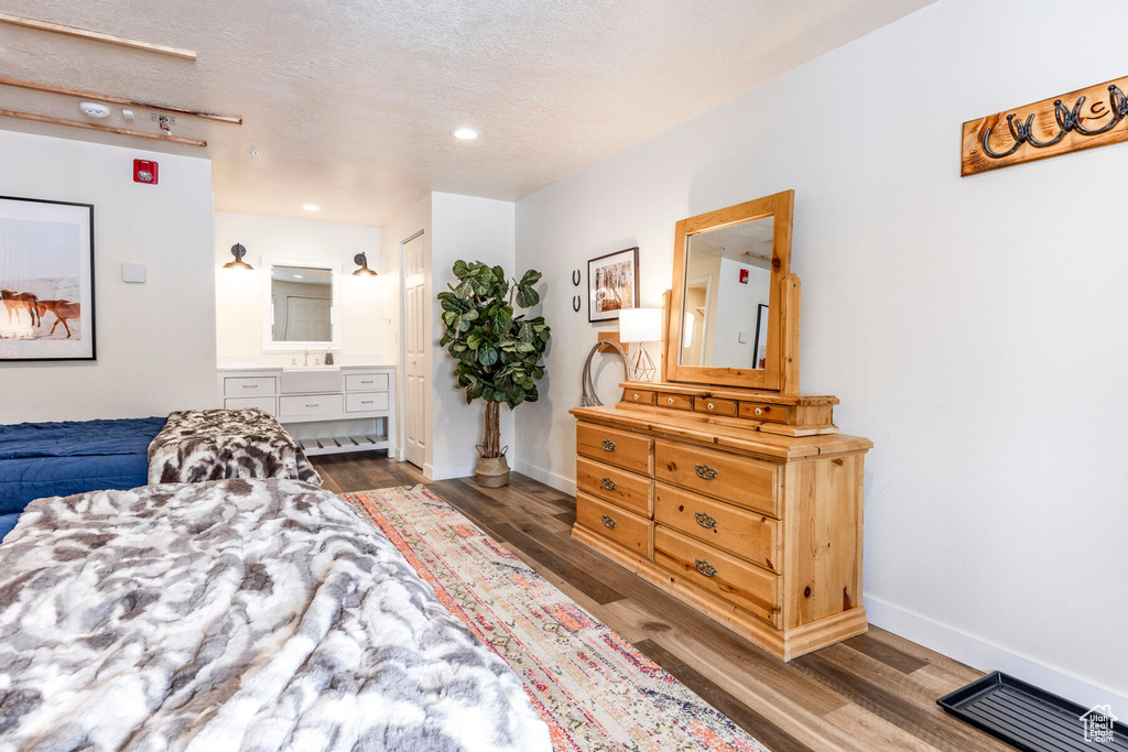Bedroom with dark wood-type flooring and a textured ceiling