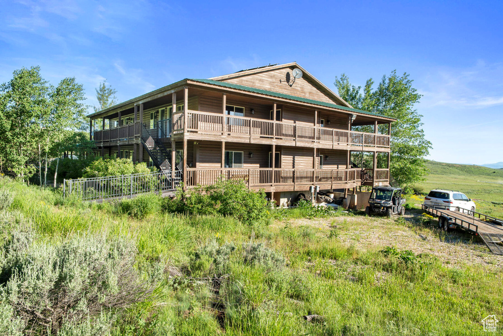 Rear view of house with a wooden deck