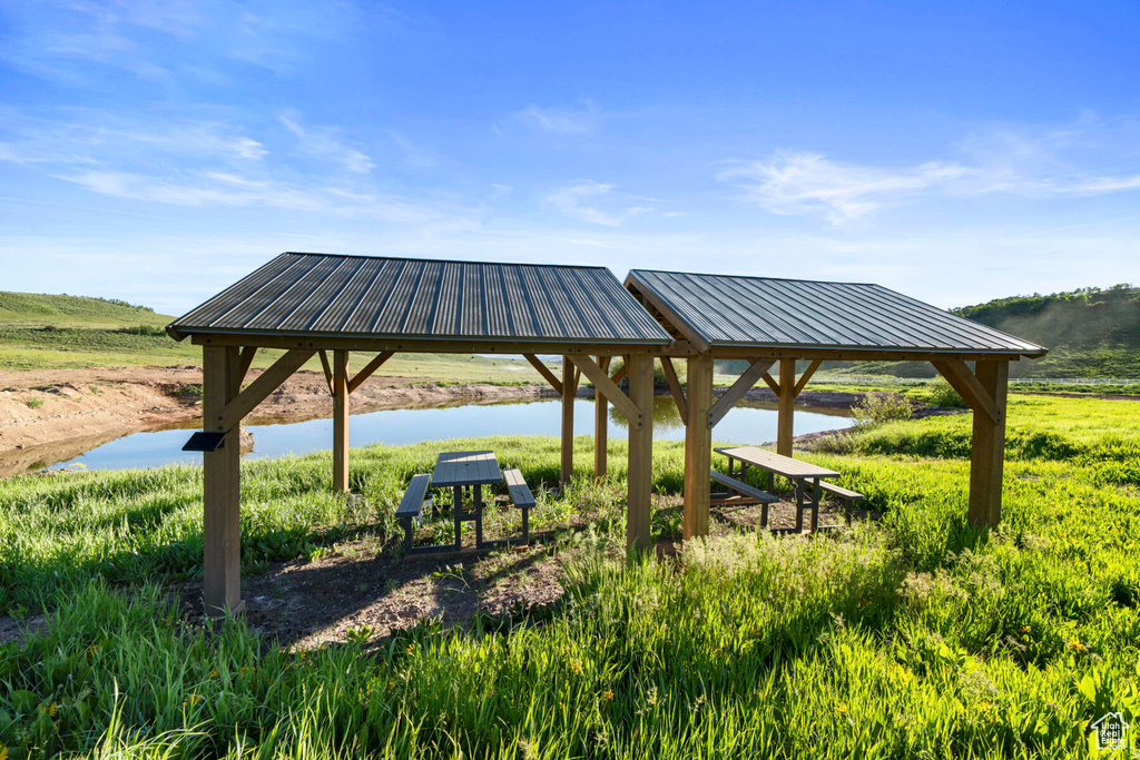 View of home's community with a water view and a gazebo