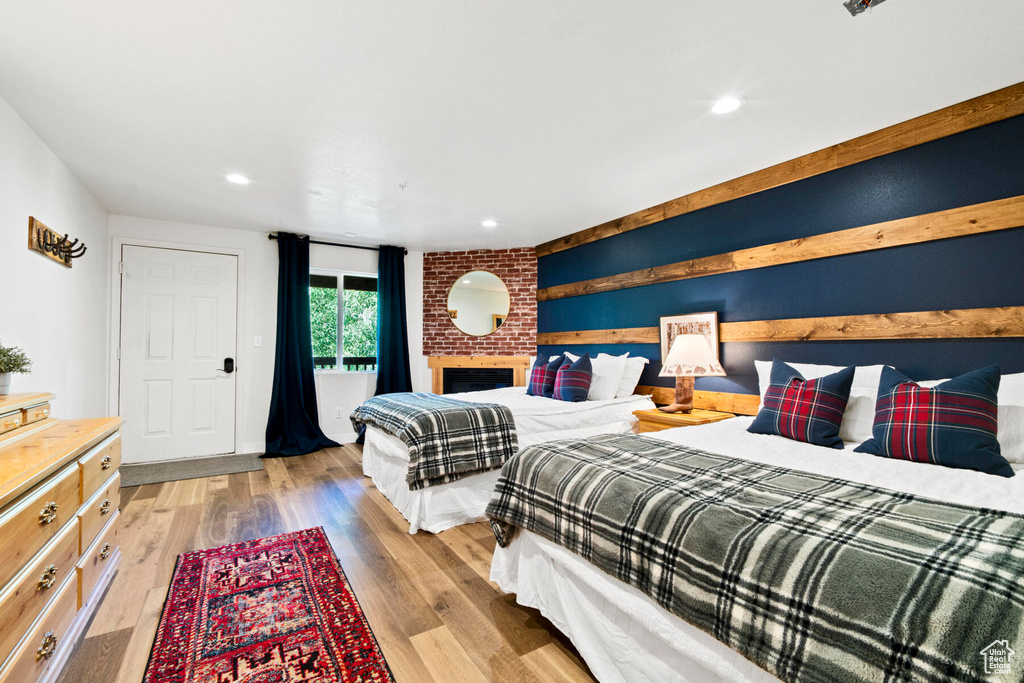 Bedroom featuring light hardwood / wood-style floors and a fireplace