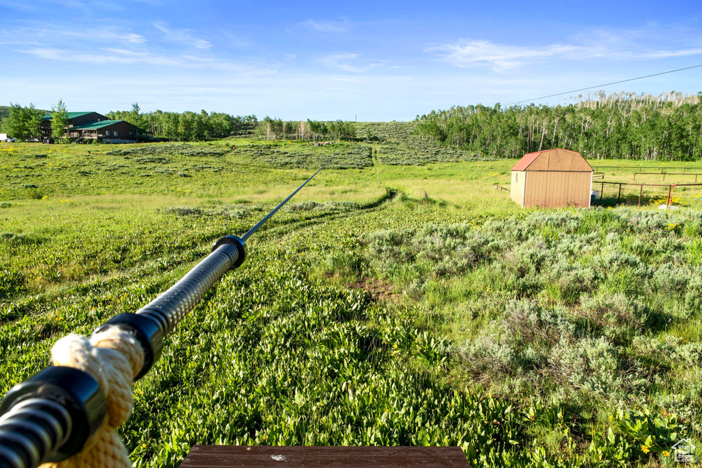 View of yard featuring a shed and a rural view