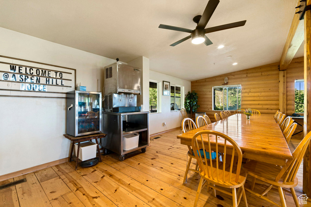 Dining room featuring ceiling fan, lofted ceiling, a healthy amount of sunlight, and light hardwood / wood-style floors
