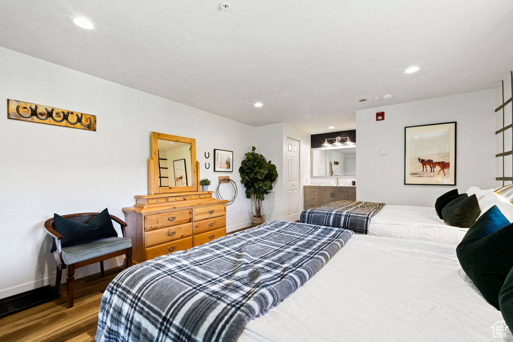 Bedroom with hardwood / wood-style floors and ensuite bathroom