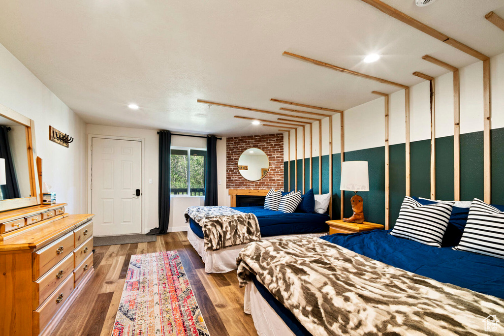 Bedroom featuring a fireplace and hardwood / wood-style flooring