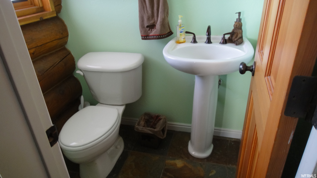 Bathroom featuring sink, tile flooring, and toilet
