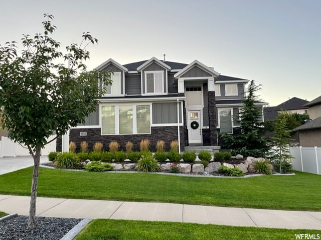 Craftsman inspired home with a front yard