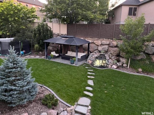 View of yard with a patio area, a trampoline, and a gazebo