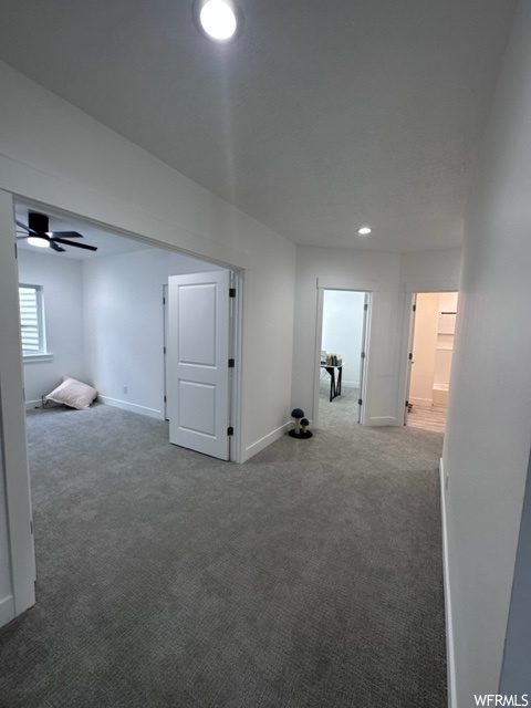Hallway featuring carpet flooring
