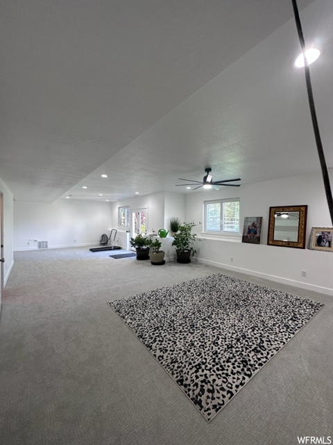 Interior space with ceiling fan and carpet floors