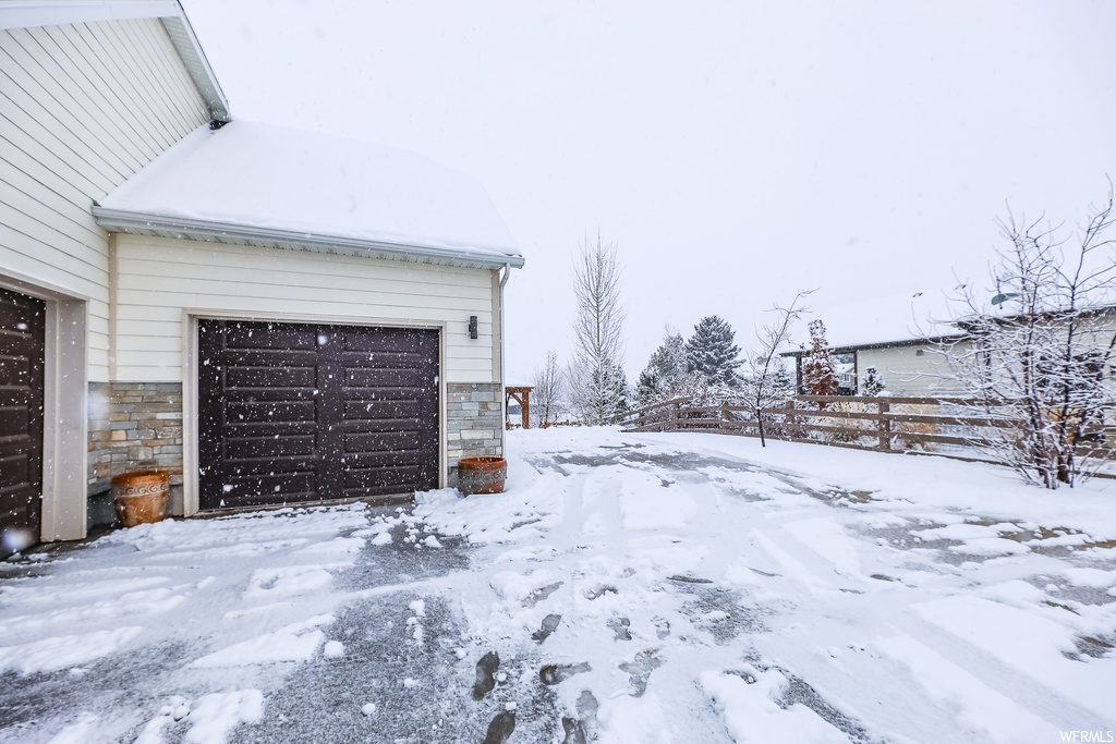 Yard covered in snow with a garage