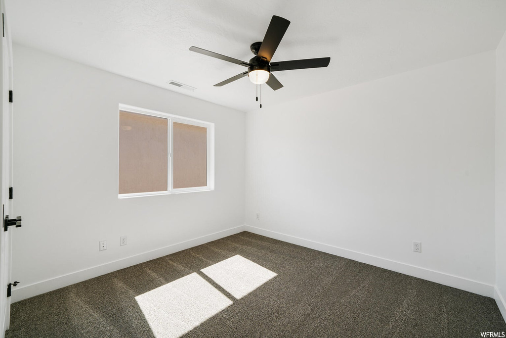 Spare room with carpet and ceiling fan