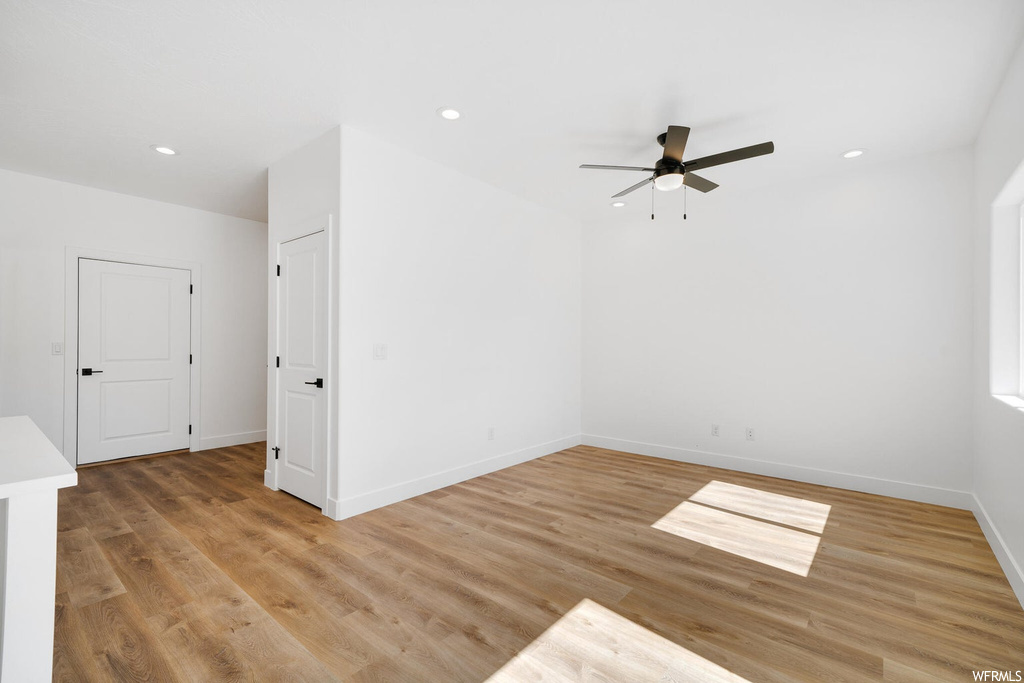 Unfurnished room featuring light hardwood floors and ceiling fan