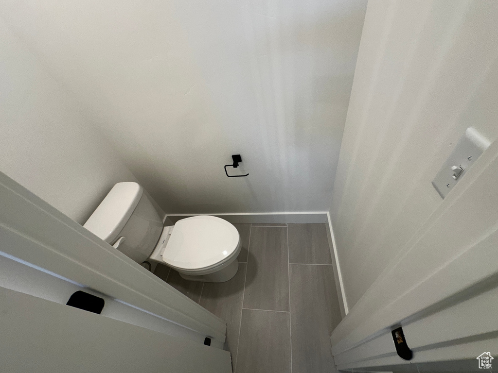 Bathroom with toilet and tile floors