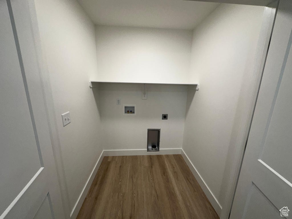 Laundry area featuring hookup for an electric dryer, hardwood / wood-style flooring, and washer hookup