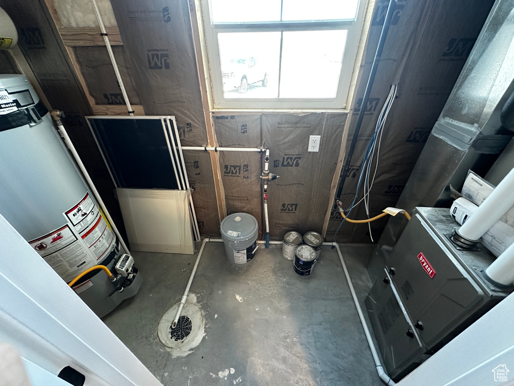 Interior space with concrete flooring and gas water heater