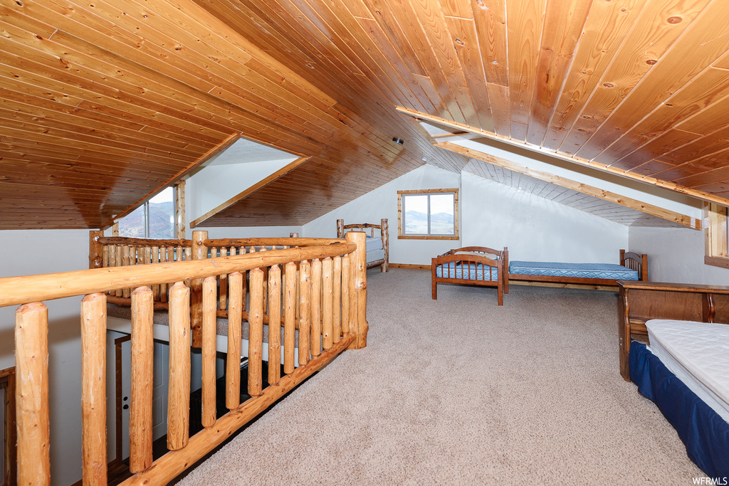 Unfurnished bedroom with lofted ceiling, light carpet, and wooden ceiling