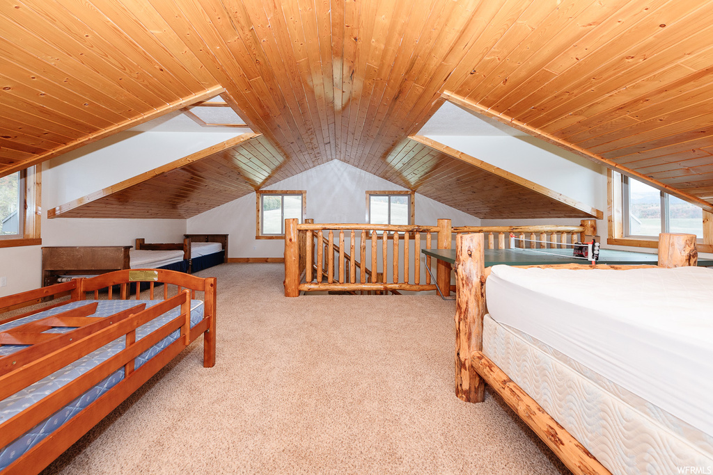Bedroom featuring lofted ceiling, light colored carpet, and wooden ceiling