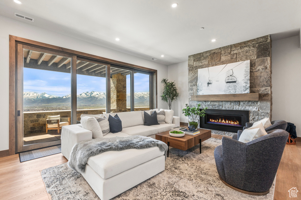 Living room featuring a mountain view, light hardwood / wood-style flooring, and a fireplace