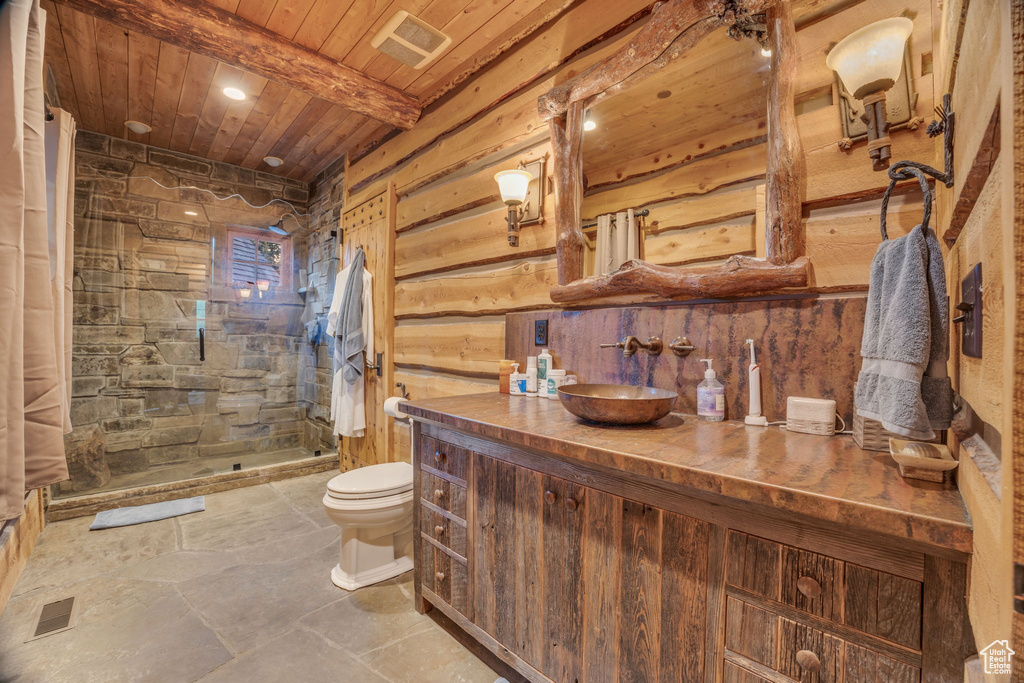 Bathroom featuring walk in shower, toilet, beam ceiling, vanity, and wood ceiling