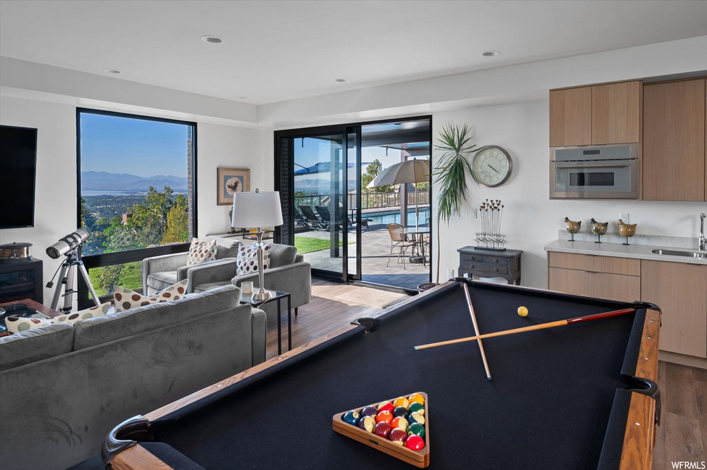 Playroom featuring hardwood flooring, pool table, sink, and a mountain view