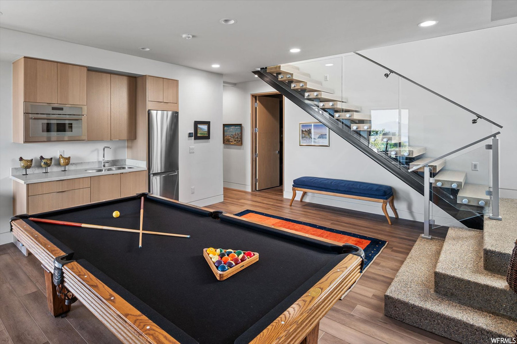Recreation room featuring sink, billiards, and light hardwood flooring