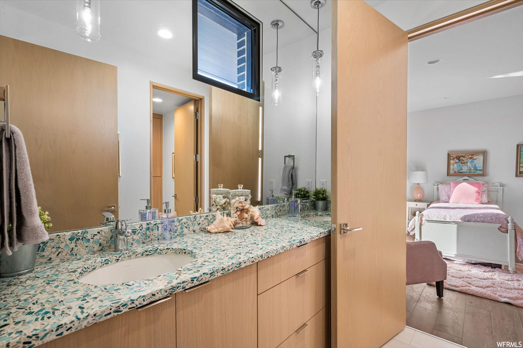Bathroom featuring oversized vanity and wood-type flooring