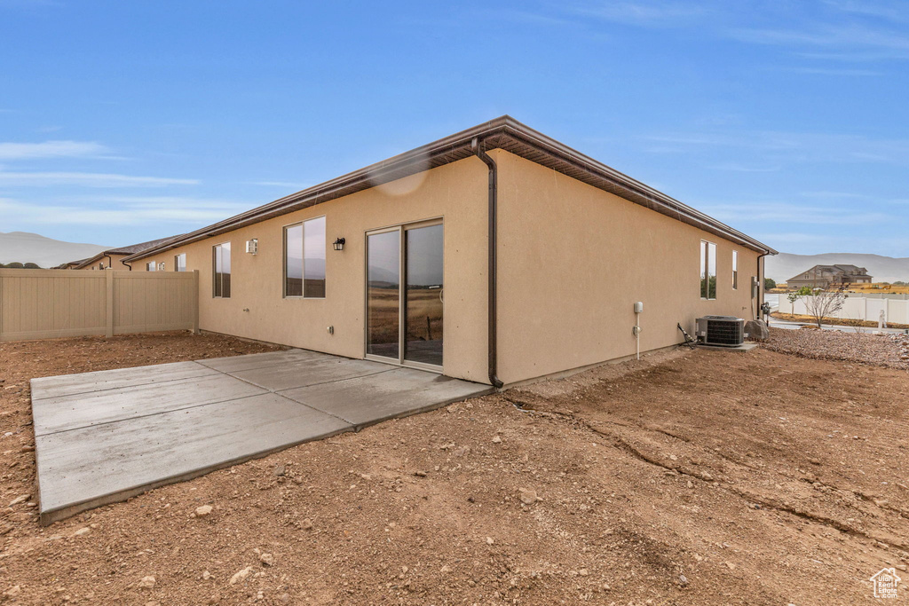 Back of property with a patio and central AC unit