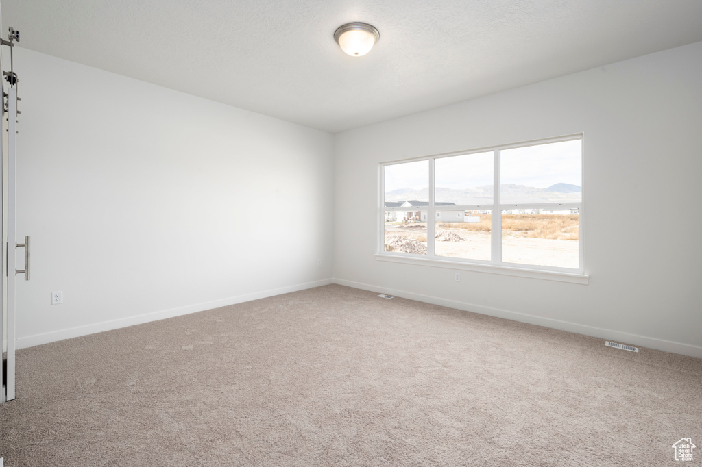 Empty room with carpet flooring