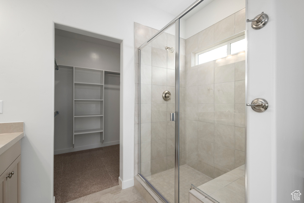 Bathroom featuring walk in shower and vanity