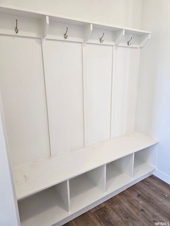 Mudroom with dark hardwood flooring