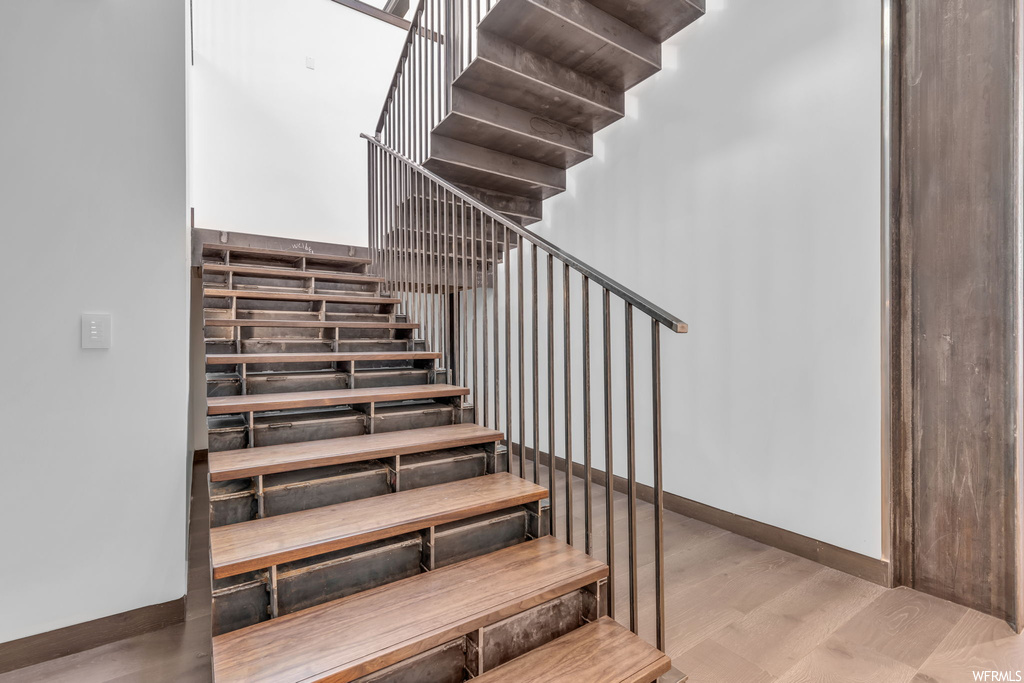 Stairs featuring light hardwood floors