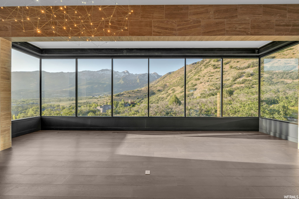 Unfurnished sunroom with a mountain view