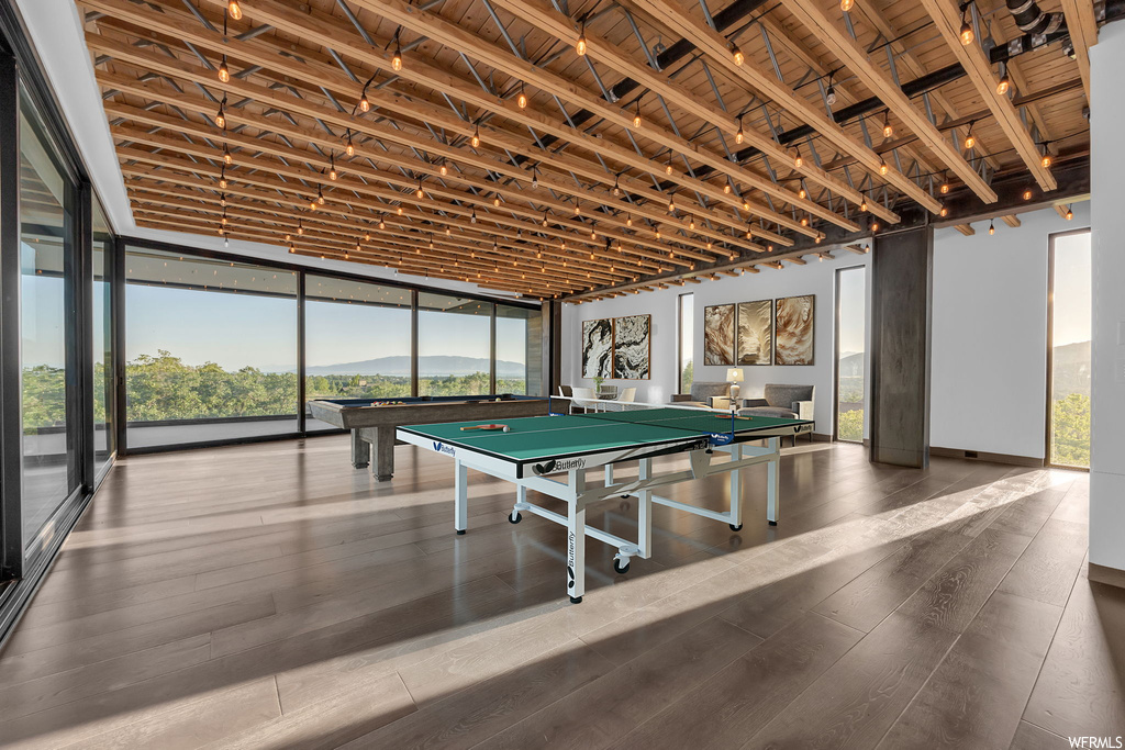 Recreation room featuring a wall of windows and hardwood floors