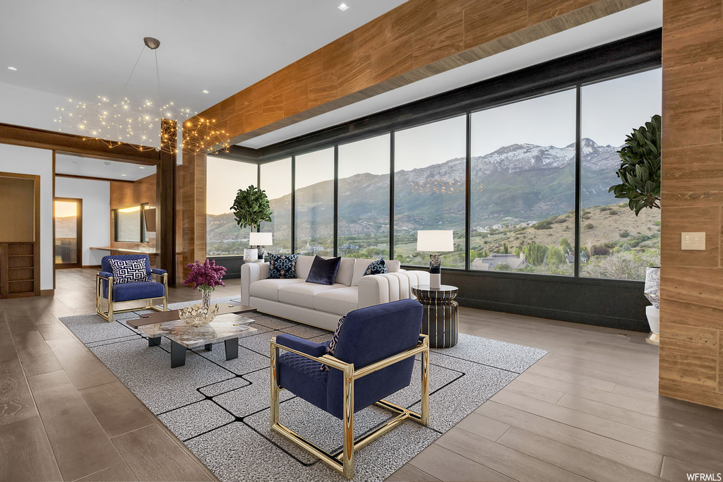 Hardwood floored living room featuring a mountain view and a chandelier