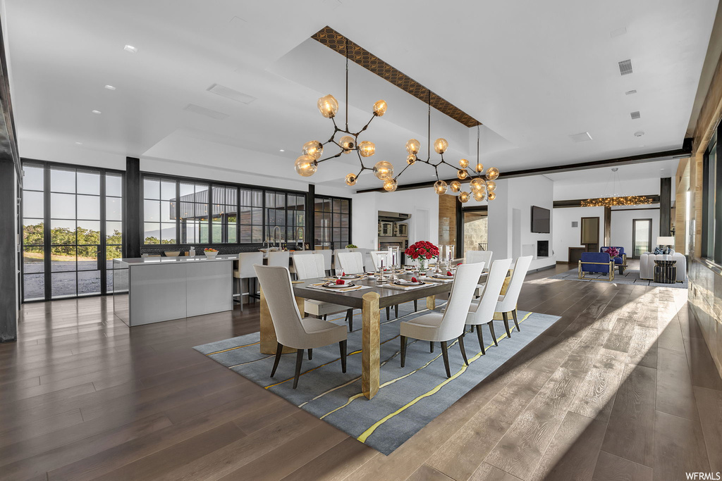 Dining room featuring dark hardwood floors and a chandelier