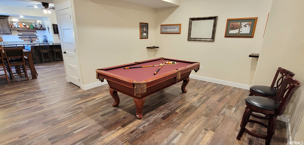 Rec room featuring bar area, dark hardwood flooring, ceiling fan, and pool table