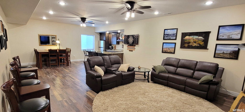 Hardwood floored living room with ceiling fan