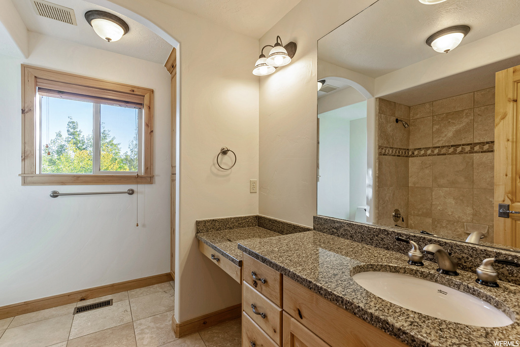 Bathroom featuring oversized vanity and tile floors
