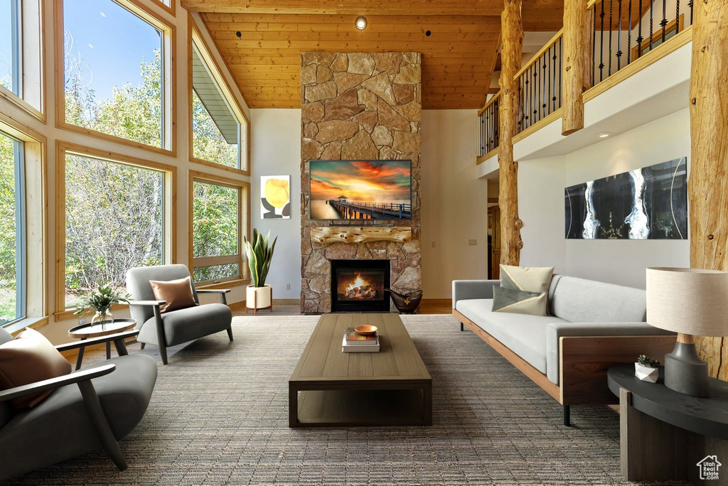 Living room featuring dark wood-type flooring, high vaulted ceiling, a fireplace, and wooden ceiling