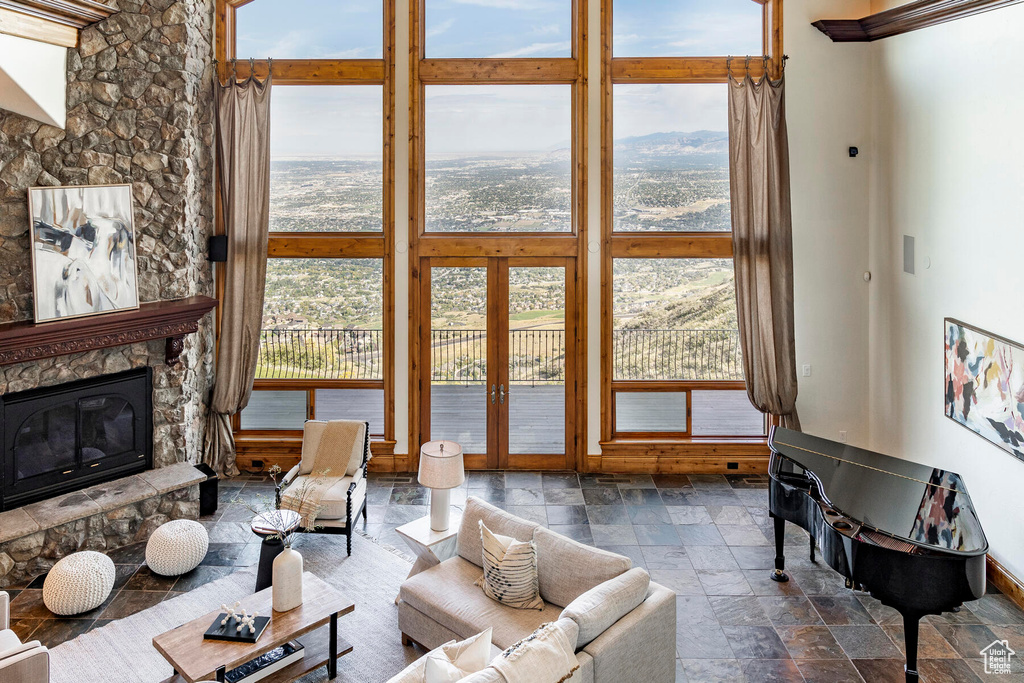 Living room featuring french doors and a stone fireplace