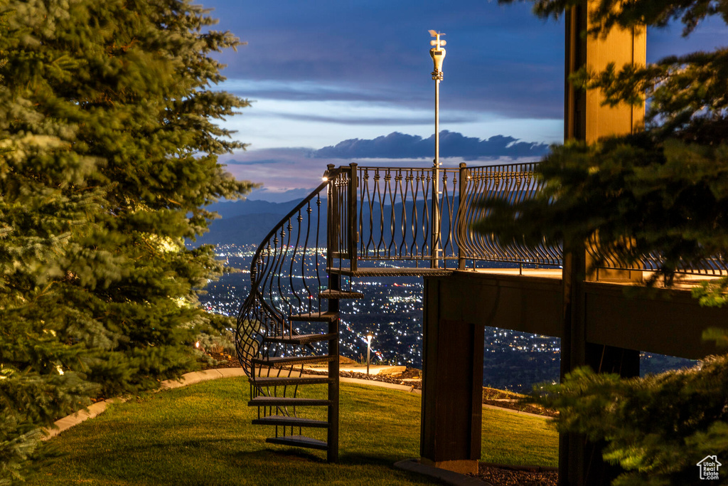 Surrounding community with a yard and a mountain view